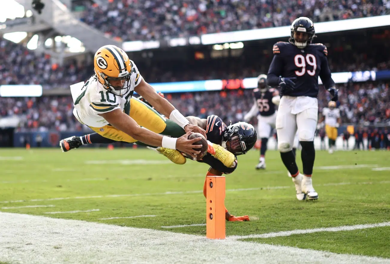 Green Bay Packers quarterback Jordan Love (10) dives at the pylon with the ball during the second half of an NFL football game against the Chicago Bear