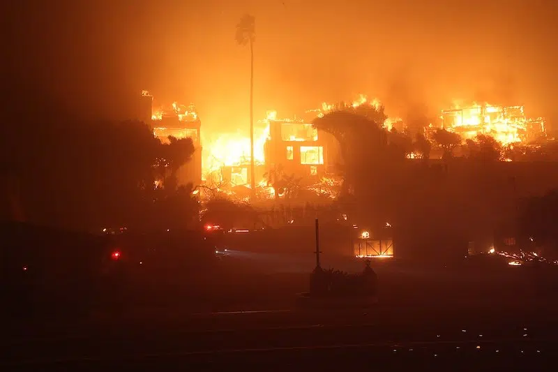 Firefighters save photo albums from a burning house in Pacific Palisades