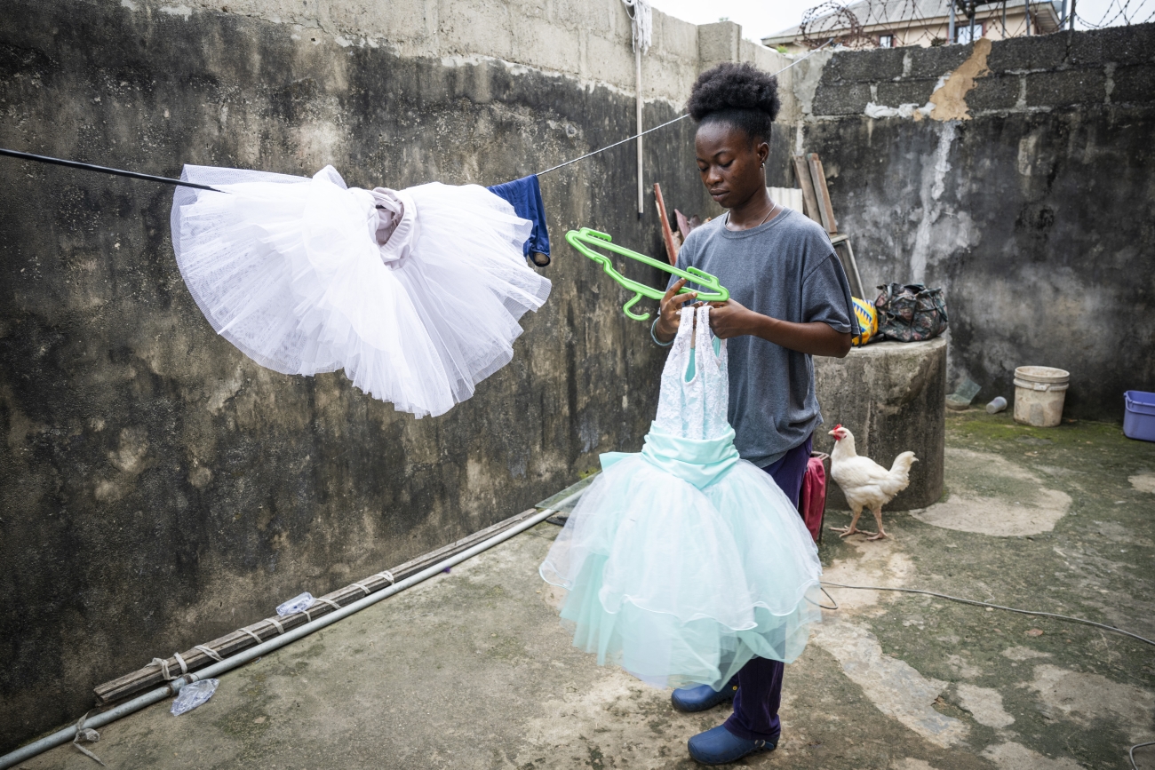 Girl in Nigeria leaving her ballet leopards out to dry